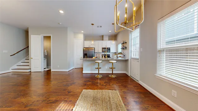 a view of a room with wooden floor and white walls