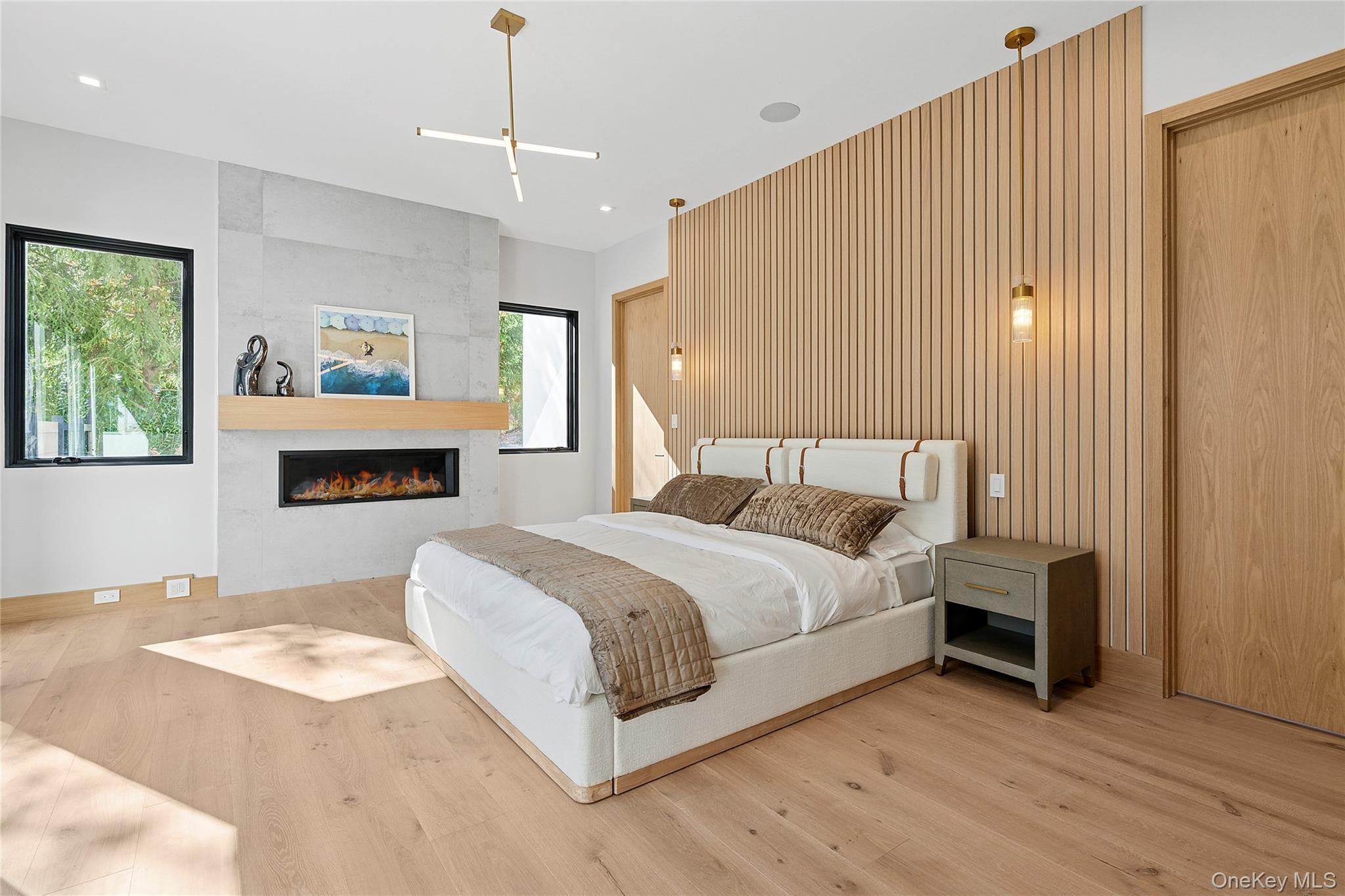 35 Springwood Way East Hampton, NY 11937 - Photo 13 of 38 a spacious bedroom with a bed and a flat screen tv