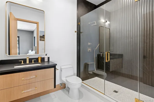 a bathroom with a toilet a sink and shower