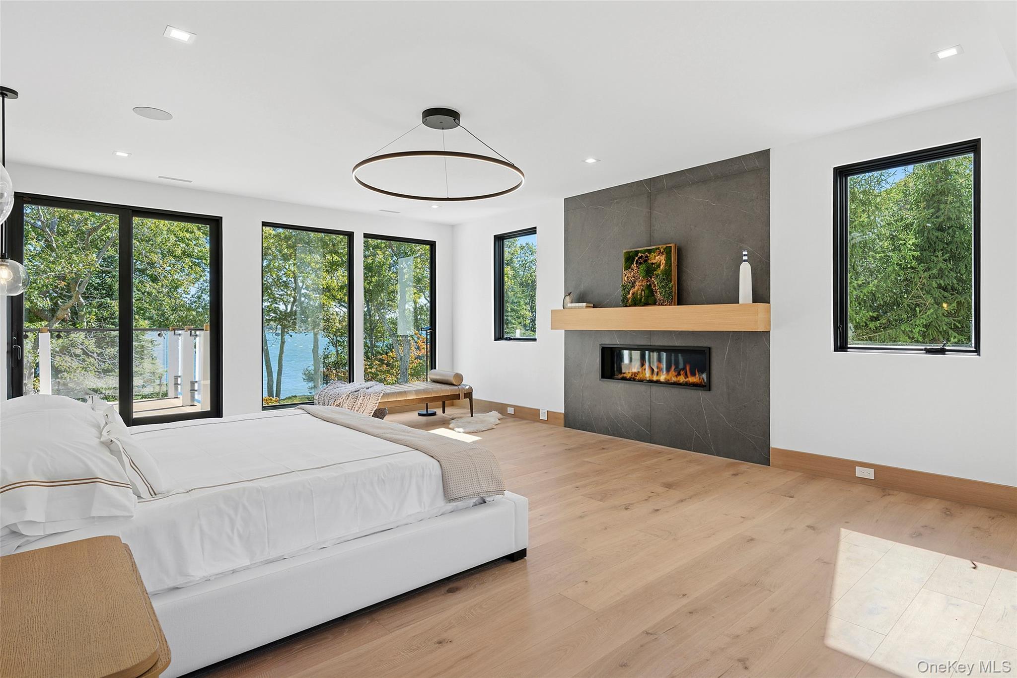 35 Springwood Way East Hampton, NY 11937 - Photo 21 of 38 a spacious bedroom with a bed and a large window