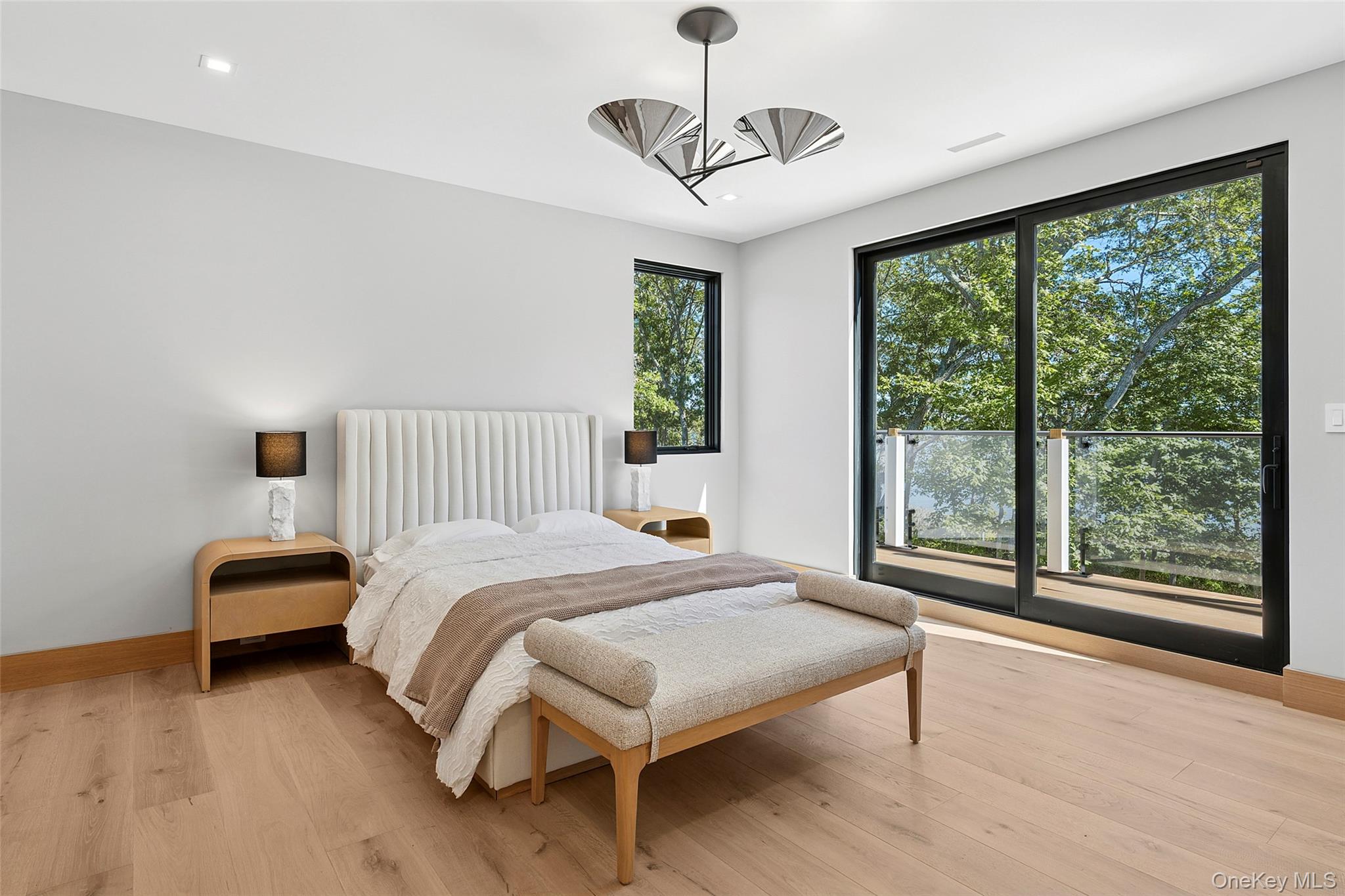 35 Springwood Way East Hampton, NY 11937 - Photo 23 of 26 a bedroom with a bed lamps and a large window