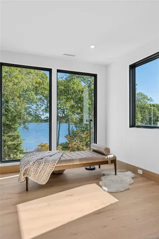 a bedroom with a bed and glass window