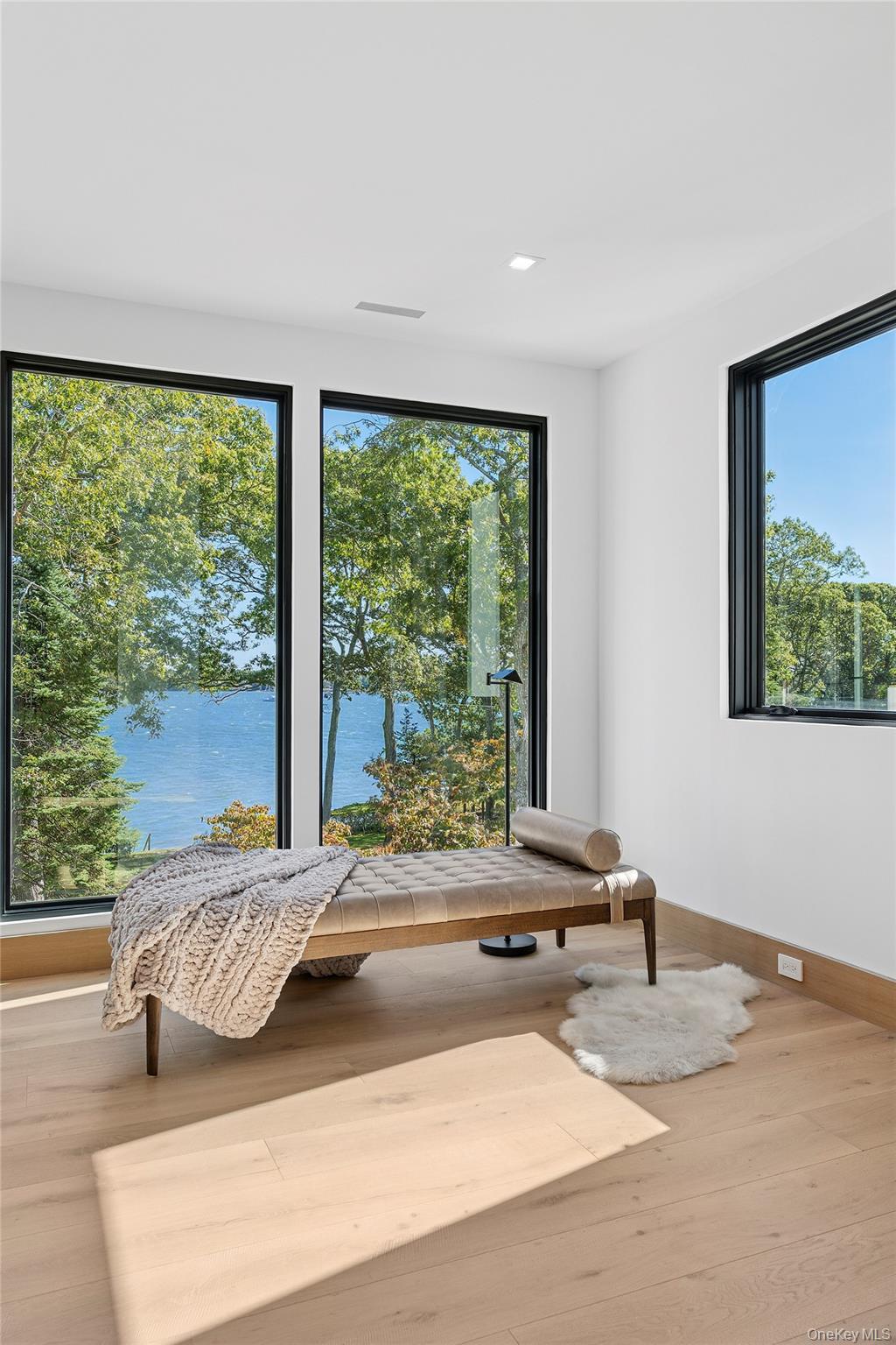 35 Springwood Way East Hampton, NY 11937 - Photo 23 of 38 a bedroom with a bed and glass window