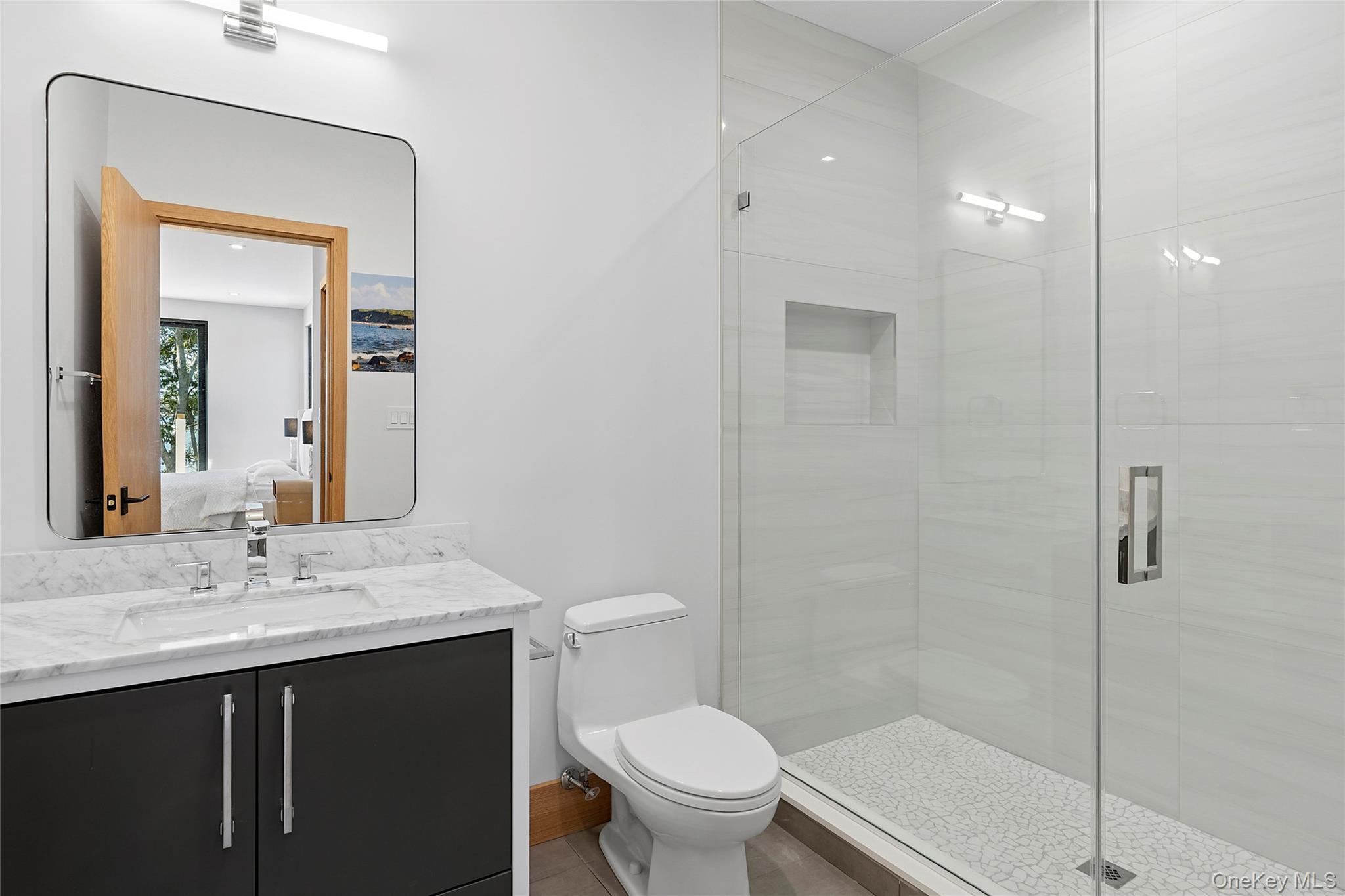 35 Springwood Way East Hampton, NY 11937 - Photo 24 of 26 a bathroom with a sink a toilet and shower