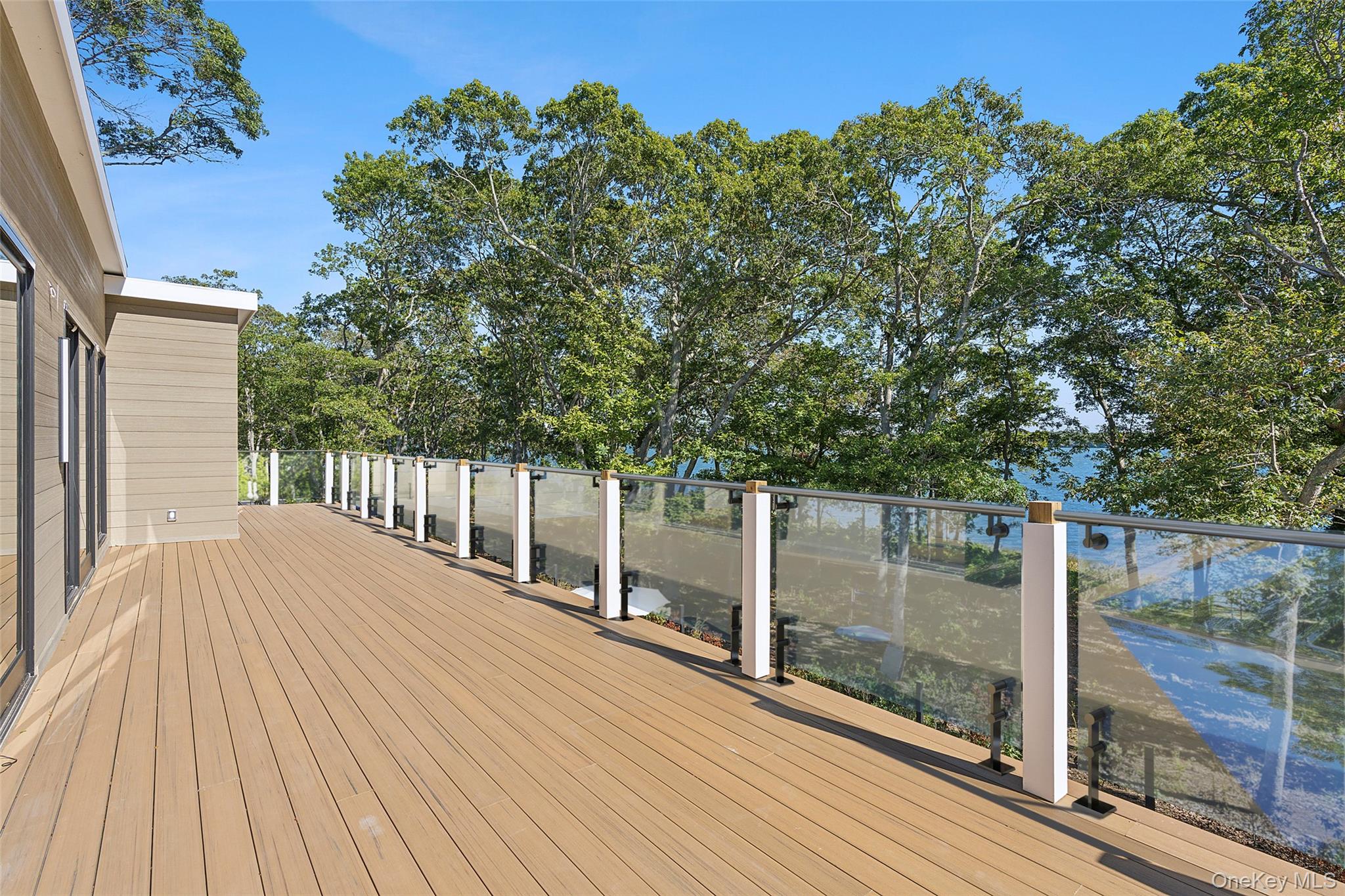 35 Springwood Way East Hampton, NY 11937 - Photo 25 of 26 a balcony with view of trees in front of it