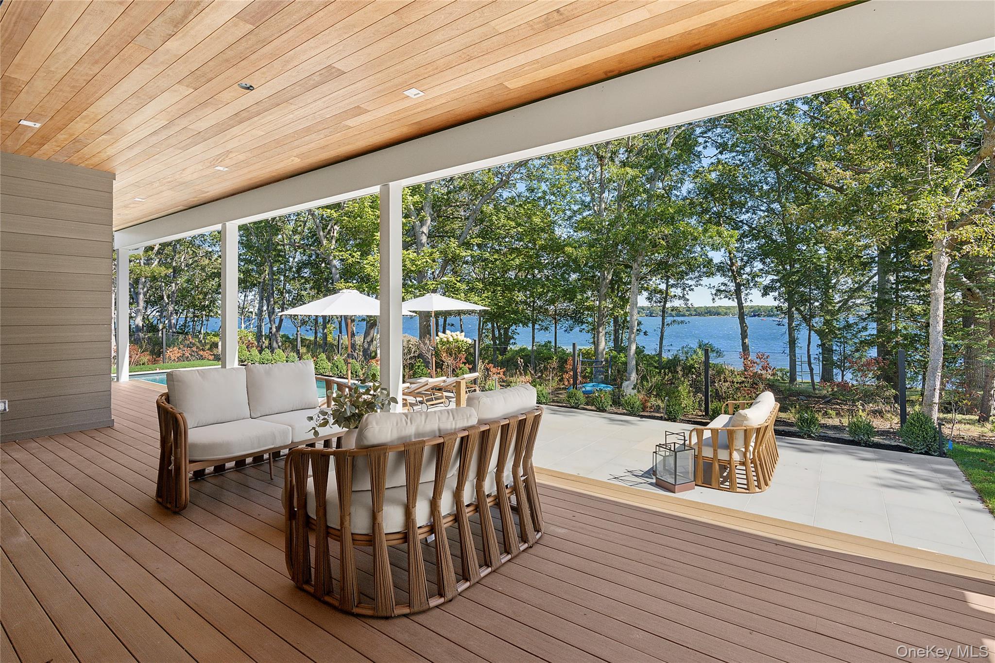 35 Springwood Way East Hampton, NY 11937 - Photo 26 of 26 a view of a patio with couches table and chairs and potted plants