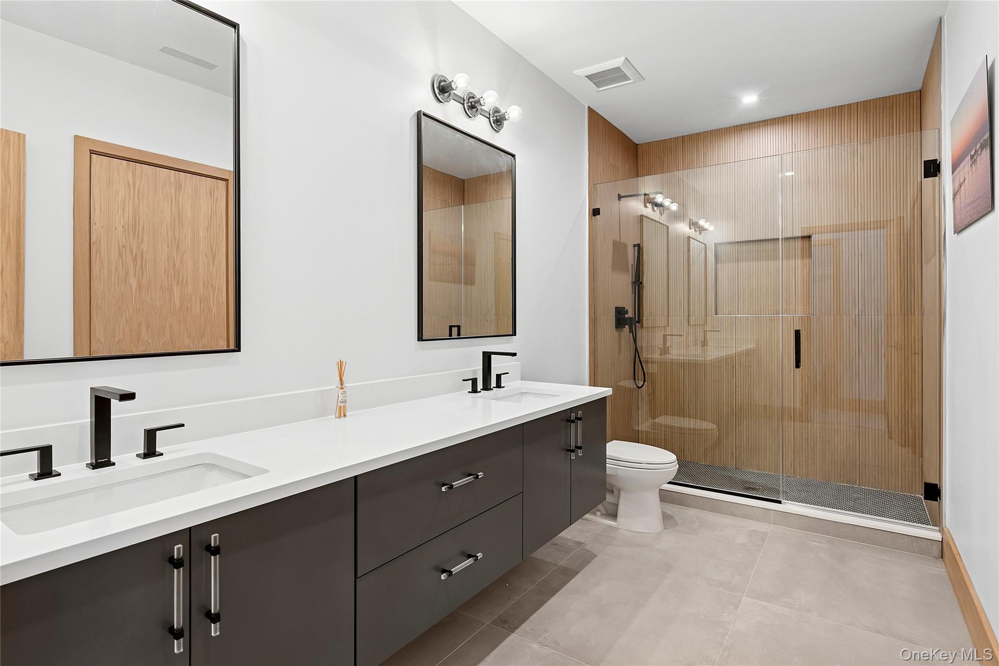 35 Springwood Way East Hampton, NY 11937 - Photo 31 of 38 a bathroom with a double vanity sink mirror double shower and a toilet