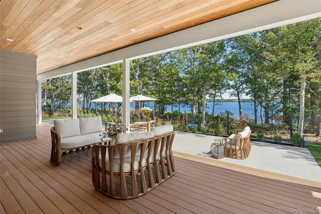 a view of a patio with couches table and chairs and potted plants