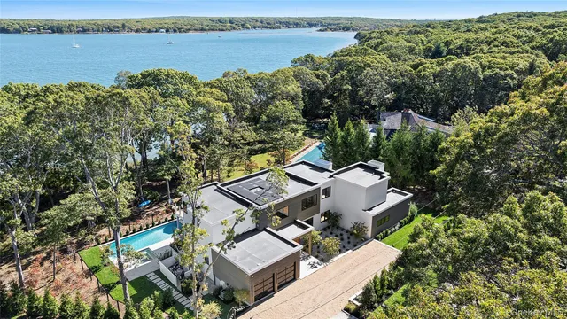 an aerial view of a house with outdoor space and lake view