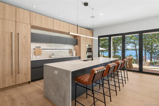 a kitchen with stainless steel appliances a table and chairs in it