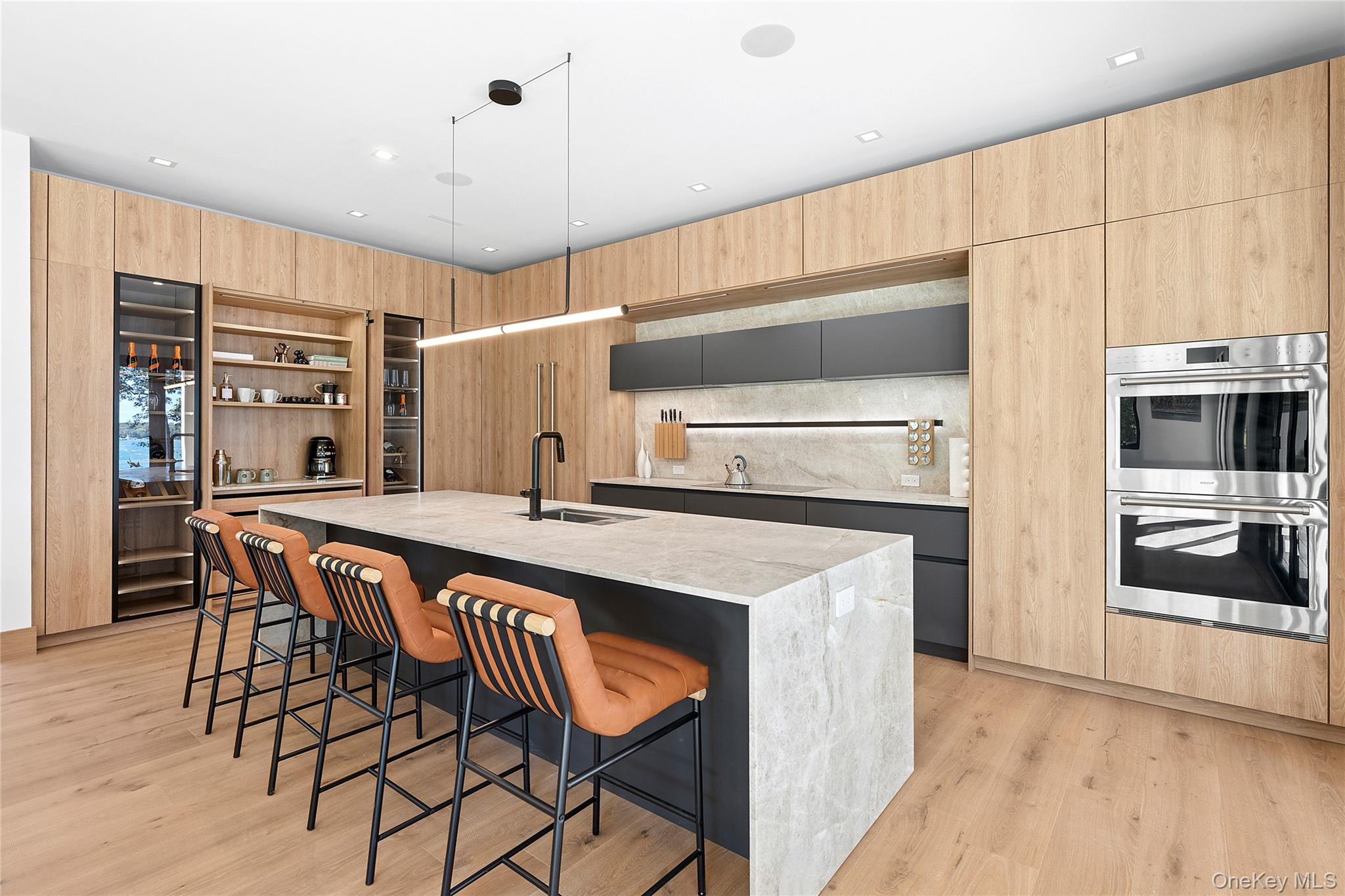 35 Springwood Way East Hampton, NY 11937 - Photo 7 of 26 a kitchen with stainless steel appliances granite countertop a stove a refrigerator and a dining table with wooden floors