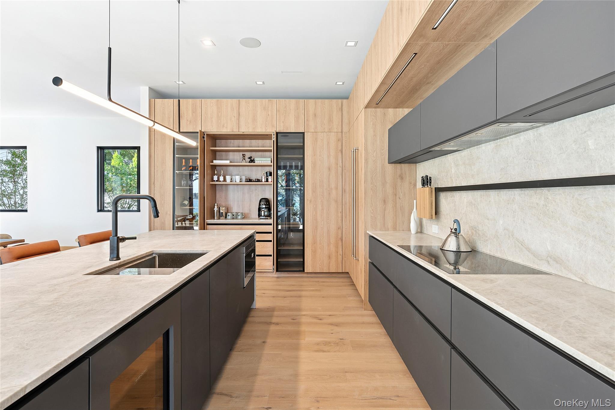 35 Springwood Way East Hampton, NY 11937 - Photo 9 of 38 a large kitchen with granite countertop a sink and a wooden floors