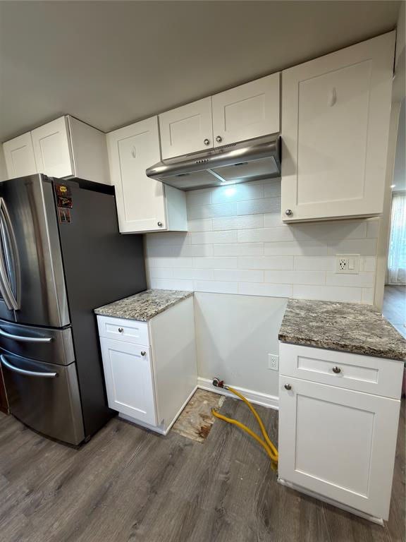 2426 May Lane Grand Prairie, TX 75050 - Photo 3 of 20 a kitchen with granite countertop white cabinets and stainless steel appliances