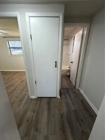 a view of a hallway with wooden floor and a hallway