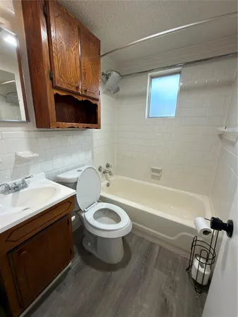 a bathroom with a sink a toilet and bathtub