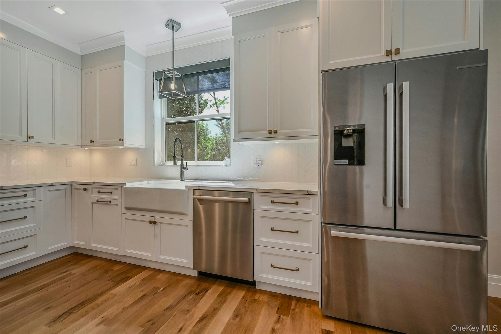 1665 Glenn Road Southold, NY 11971 - Photo 10 of 34 a kitchen with a refrigerator and a sink