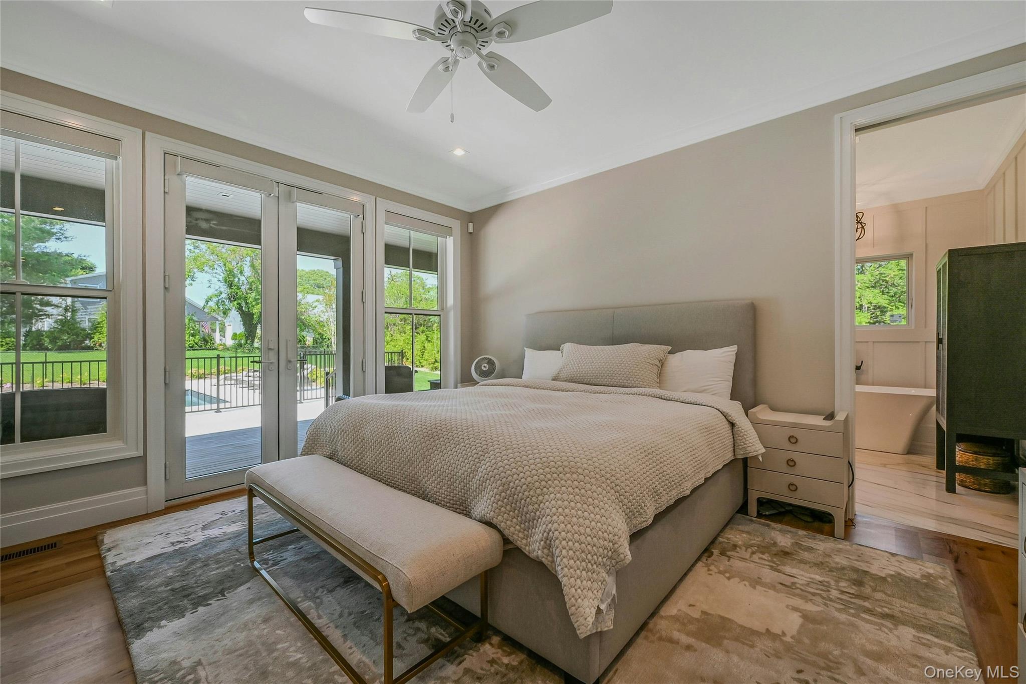 1665 Glenn Road Southold, NY 11971 - Photo 12 of 34 a bedroom with a bed and large window