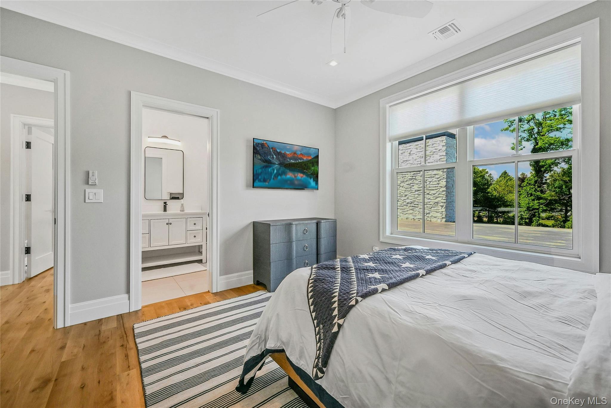 1665 Glenn Road Southold, NY 11971 - Photo 22 of 34 a bedroom with a bed and a flat screen tv