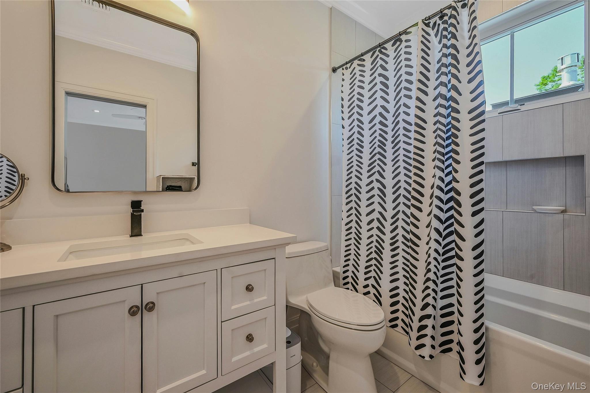 1665 Glenn Road Southold, NY 11971 - Photo 23 of 34 a bathroom with a sink a toilet and a mirror