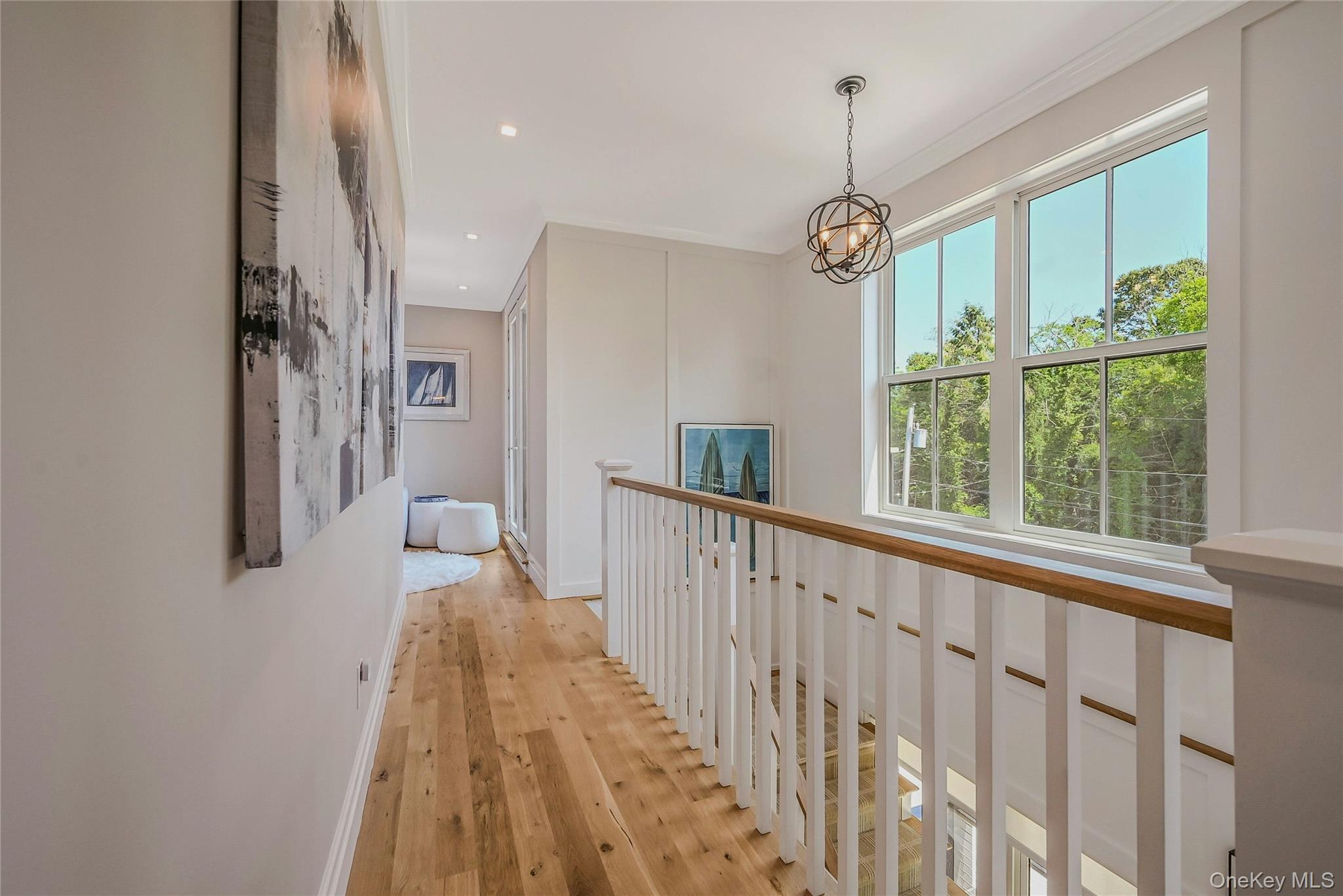 1665 Glenn Road Southold, NY 11971 - Photo 28 of 34 a view of hallway with wooden floor and windows