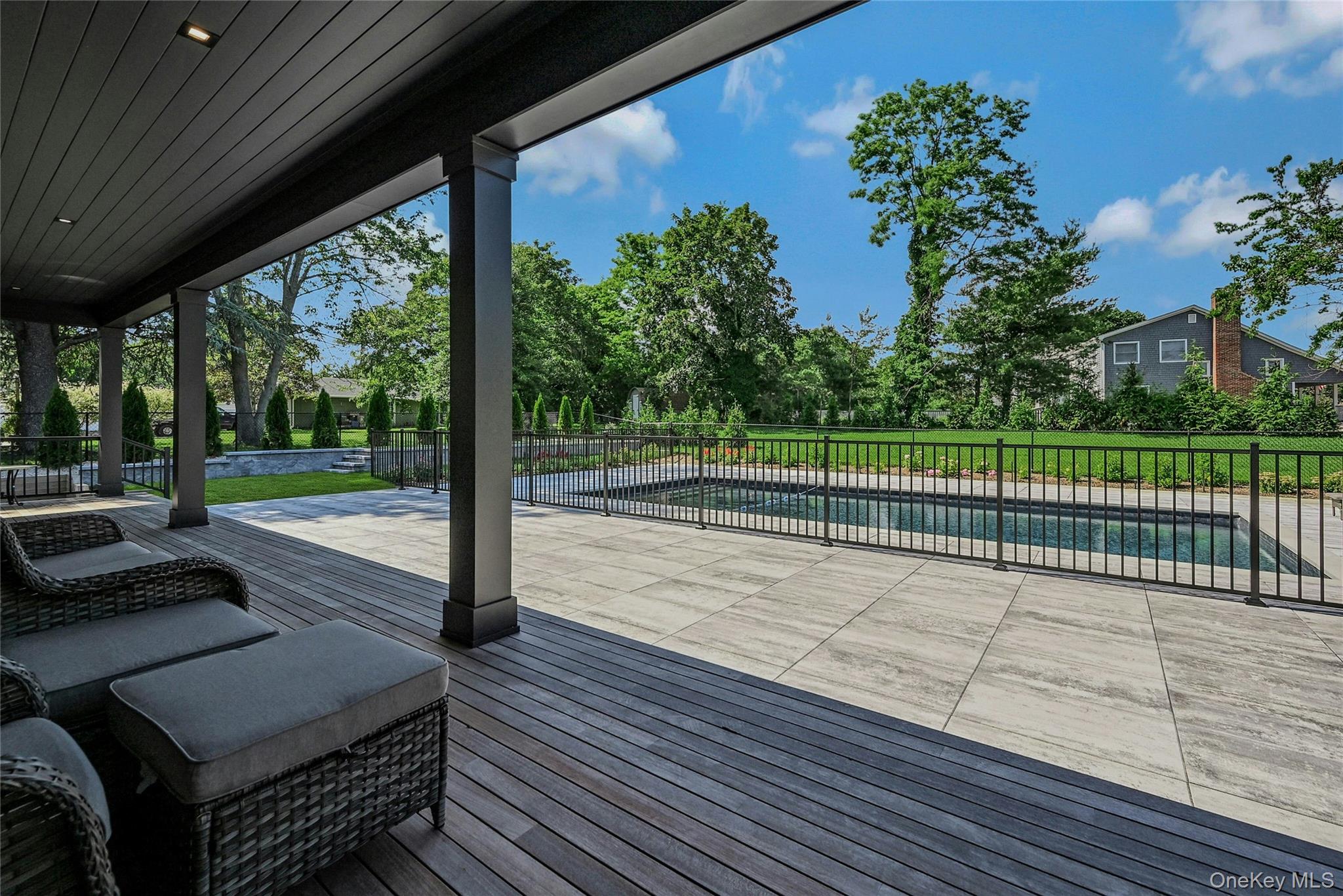 1665 Glenn Road Southold, NY 11971 - Photo 30 of 34 a view of a deck with a floor to ceiling window with wooden floor