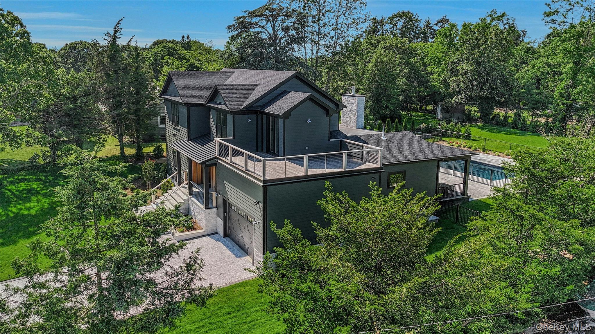 1665 Glenn Road Southold, NY 11971 - Photo 32 of 34 an aerial view of a house with yard and trees in the background
