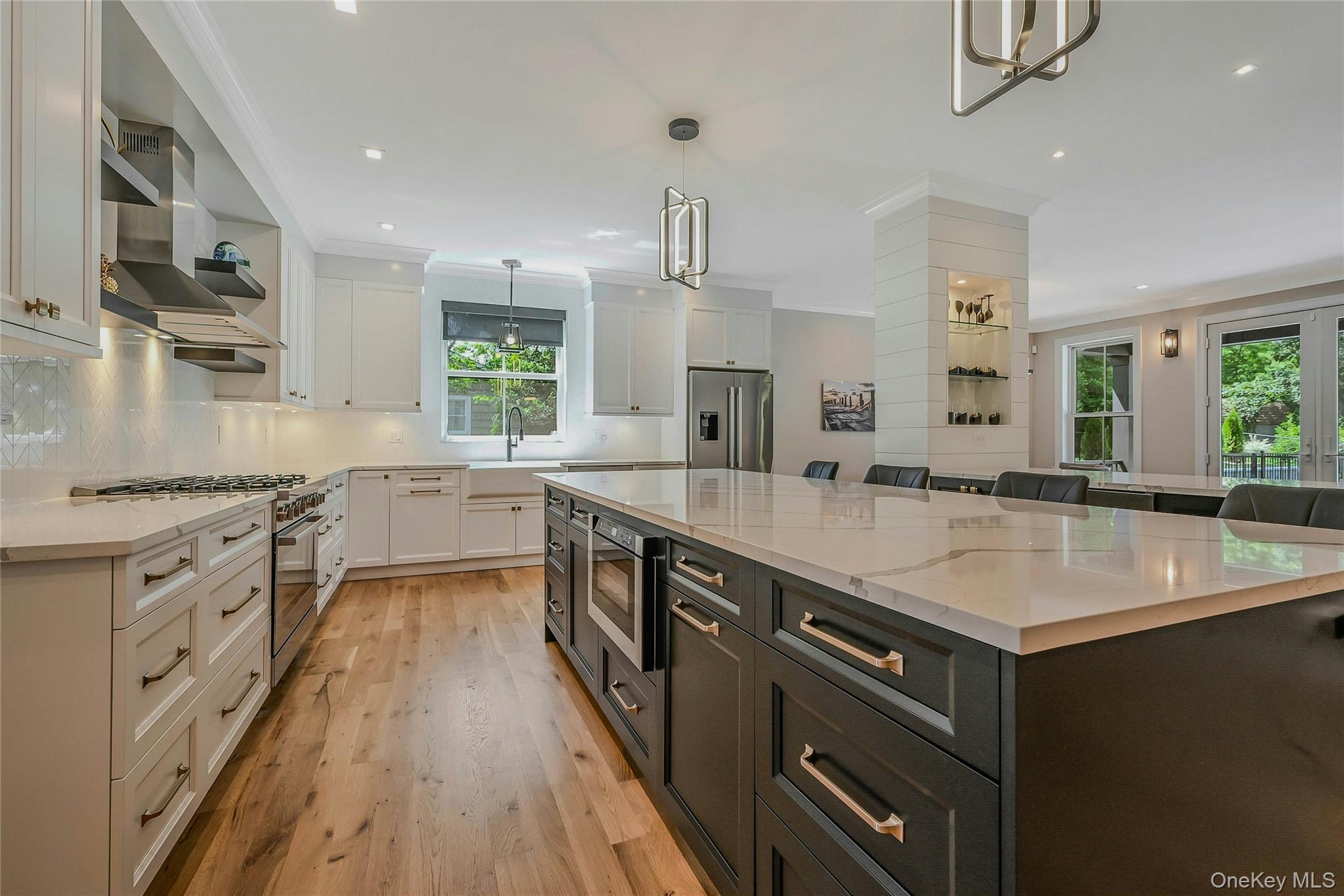 1665 Glenn Road Southold, NY 11971 - Photo 8 of 34 a large kitchen with stainless steel appliances granite countertop a sink stove and refrigerator