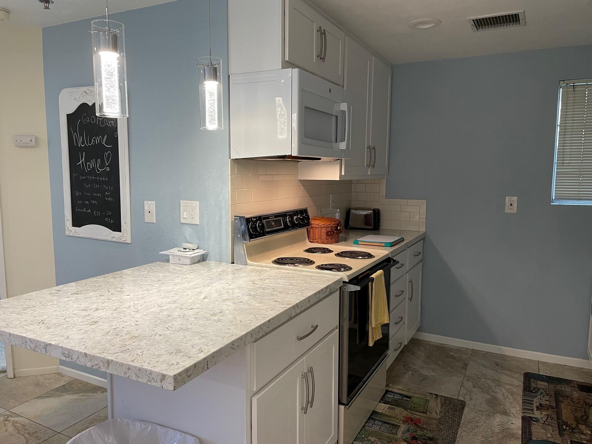2700 Lawrence Crossley Road, Unit 51 Palm Springs, CA 92264 - Photo 1 of 23 a kitchen with a stove and a sink