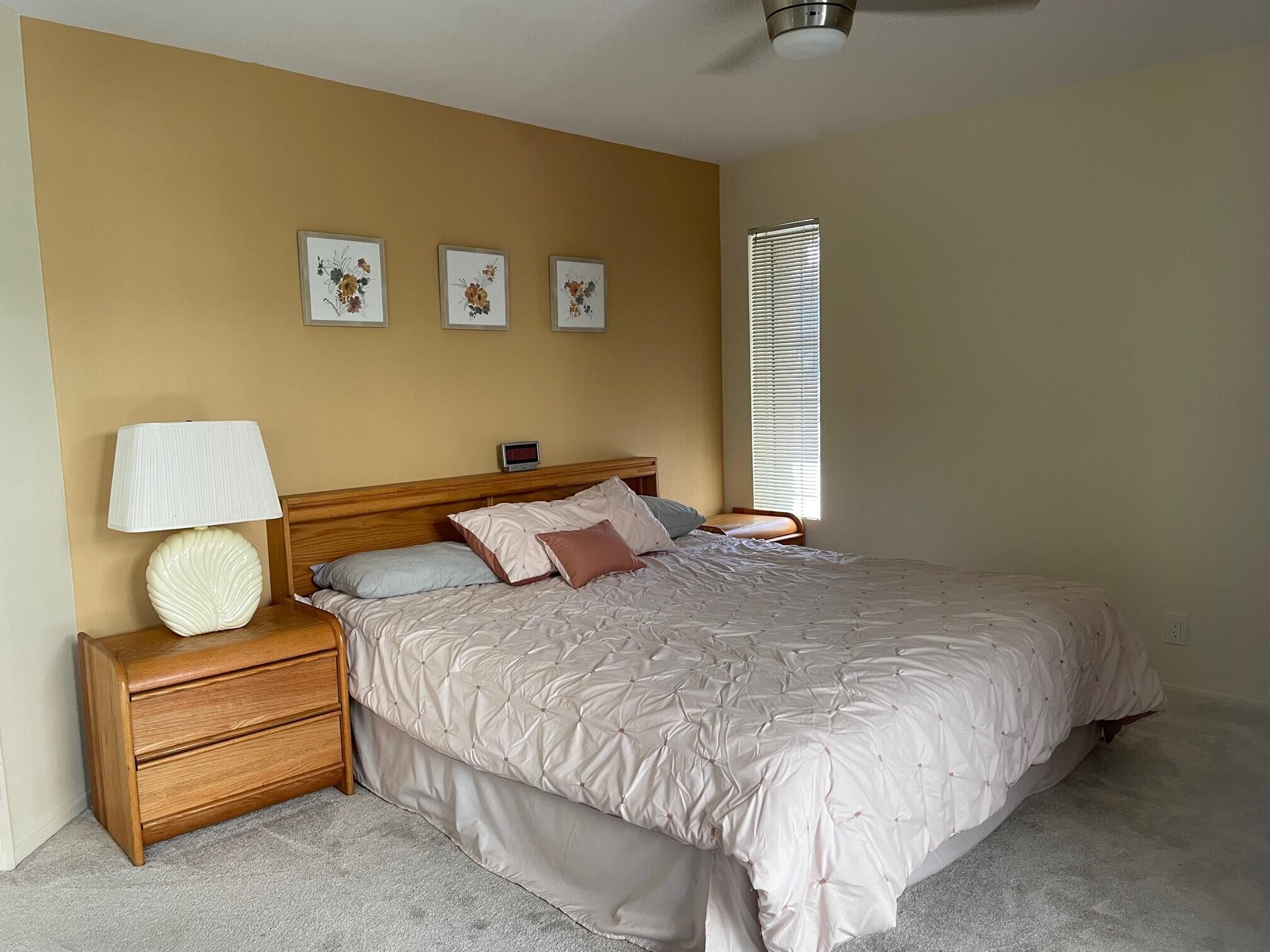 2700 Lawrence Crossley Road, Unit 51 Palm Springs, CA 92264 - Photo 14 of 23 a bedroom with a bed and a lamp on table