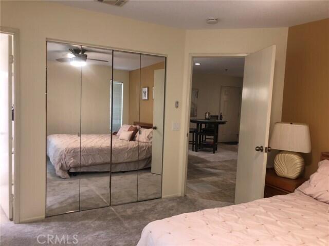 2700 Lawrence Crossley Road, Unit 51 Palm Springs, CA 92264 - Photo 15 of 23 a bedroom with a bed and mirror