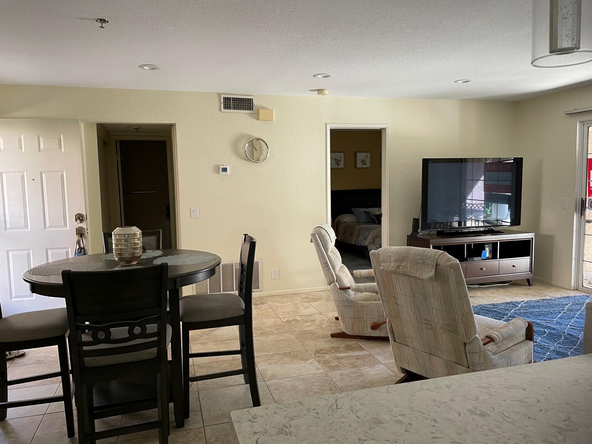 2700 Lawrence Crossley Road, Unit 51 Palm Springs, CA 92264 - Photo 3 of 23 a living room with furniture and a flat screen tv