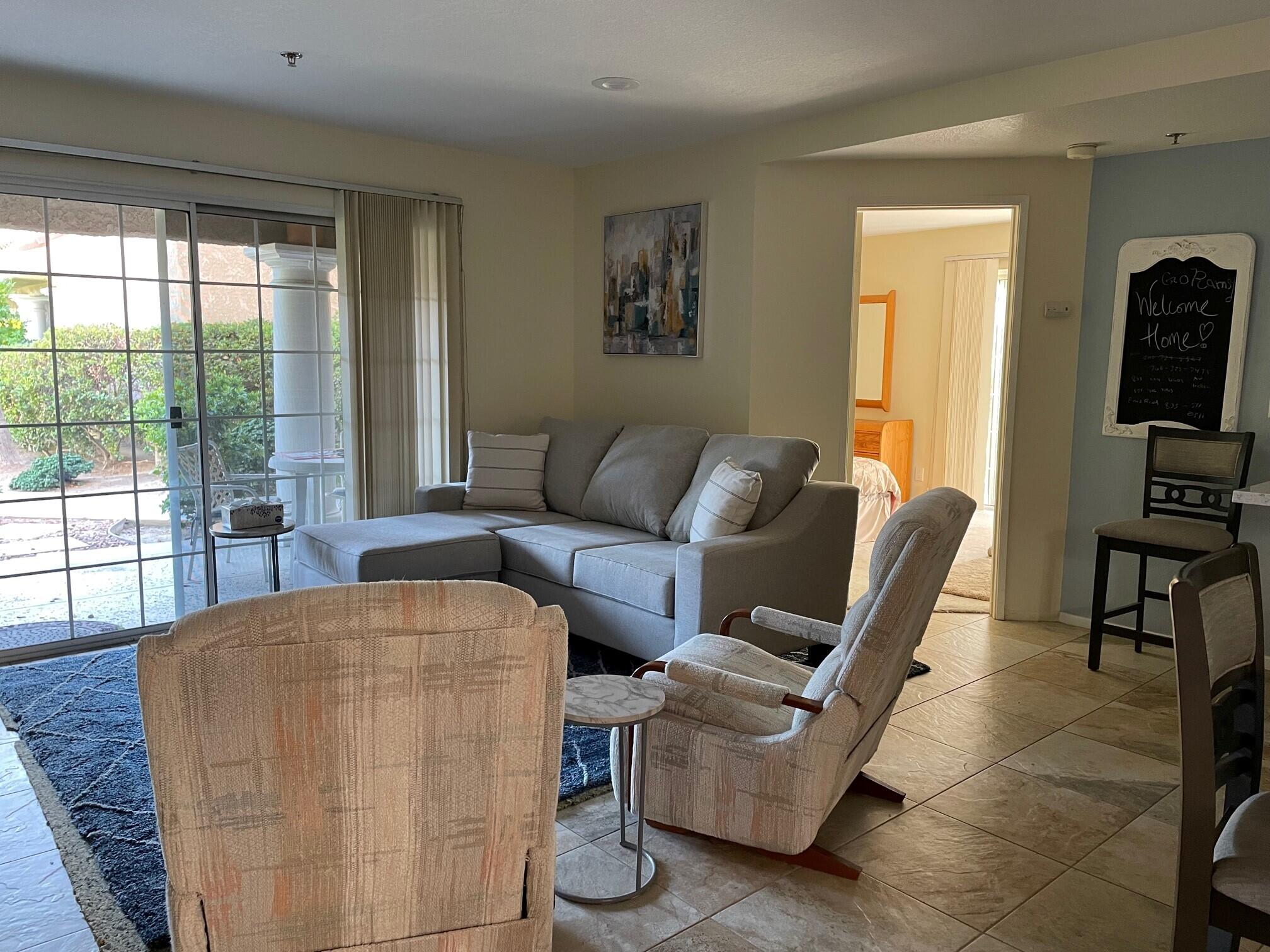 2700 Lawrence Crossley Road, Unit 51 Palm Springs, CA 92264 - Photo 7 of 23 a living room with furniture and a floor to ceiling window