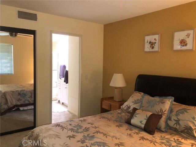 2700 Lawrence Crossley Road, Unit 51 Palm Springs, CA 92264 - Photo 10 of 23 a bedroom with a bed and wooden floor