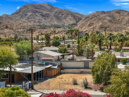 a terrace with outdoor seating and trees
