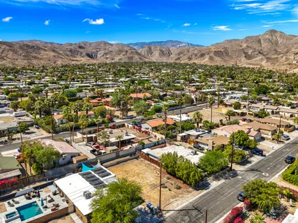 an aerial view of residential houses with outdoor space and street view