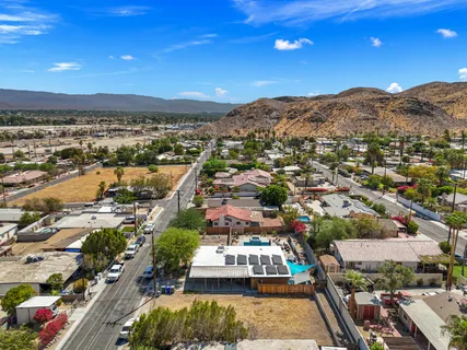 an aerial view of residential houses with outdoor space and street view