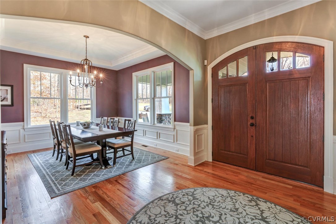 15930 Alsdell Road Midlothian, VA 23112 - Photo 6 of 50 a dining room with furniture a chandelier and wooden floor