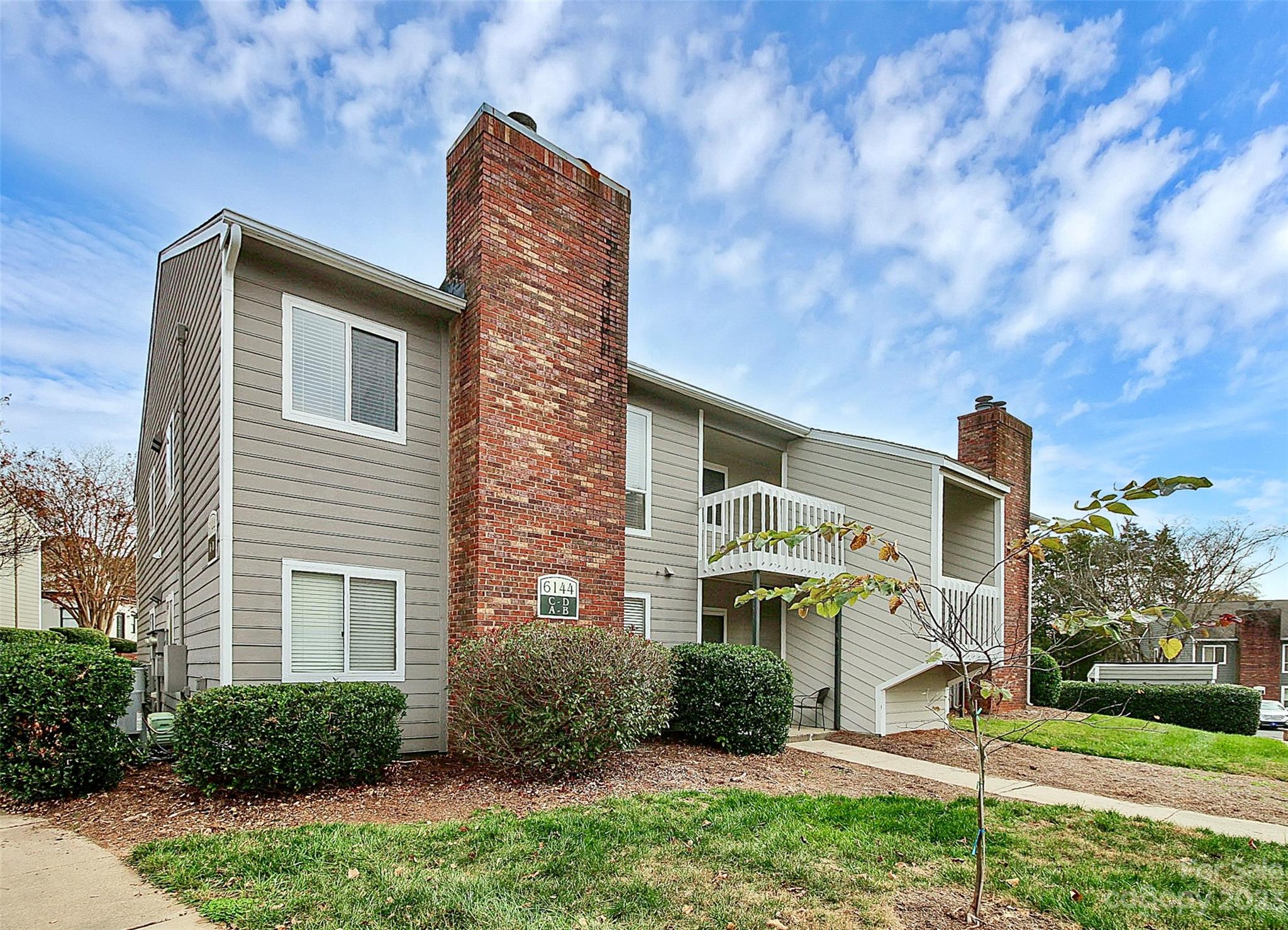 6144 Heath Ridge Court, Unit C Charlotte, NC 28210 - Photo 1 of 36 a front view of a house with a yard