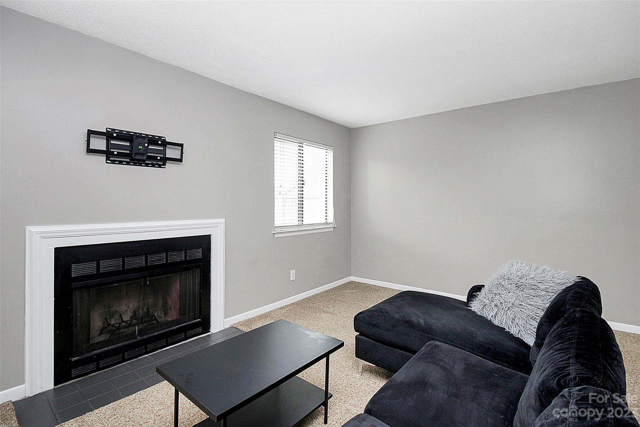6144 Heath Ridge Court, Unit C Charlotte, NC 28210 - Photo 11 of 36 a living room with furniture and a fireplace