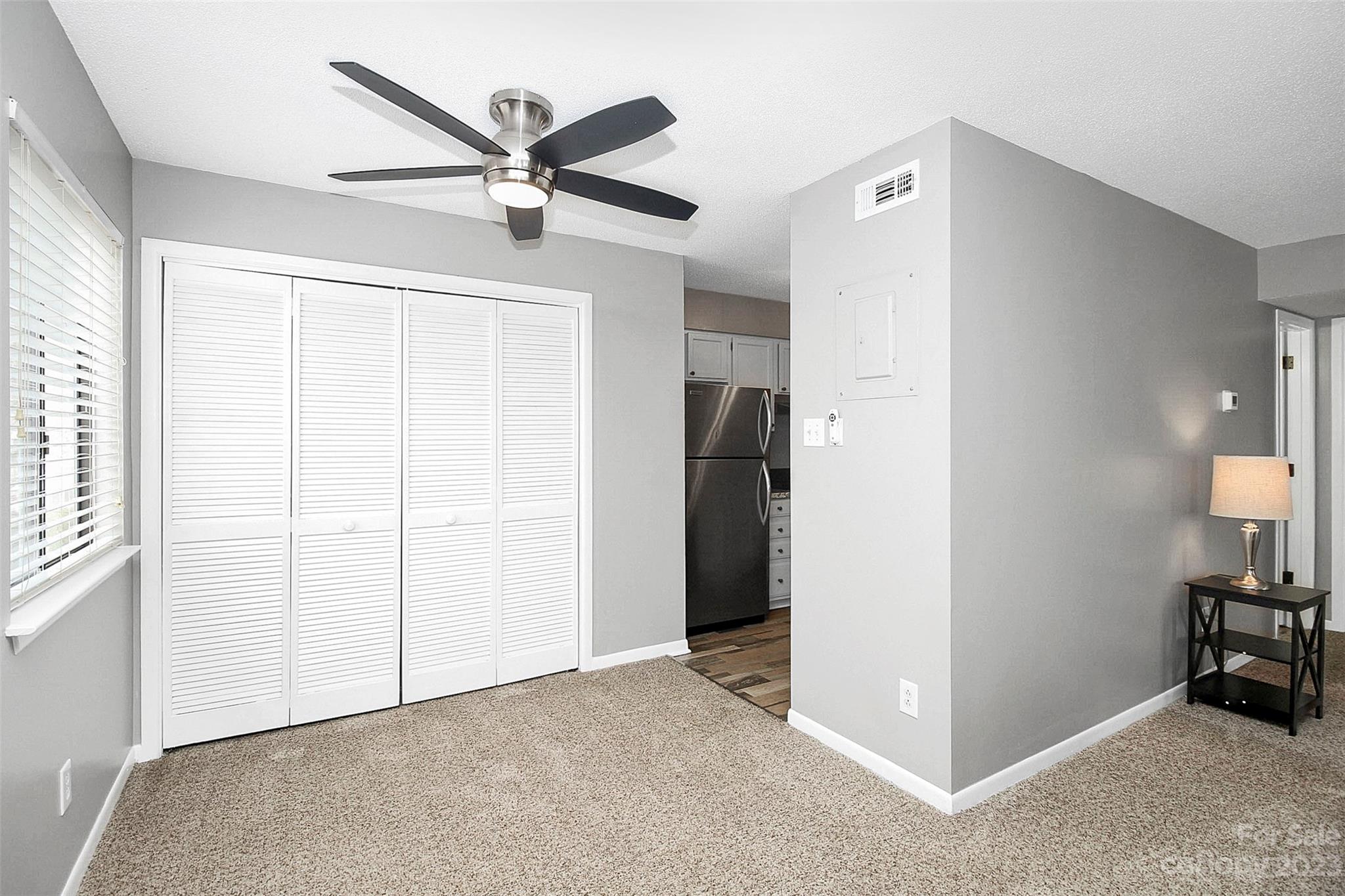 6144 Heath Ridge Court, Unit C Charlotte, NC 28210 - Photo 12 of 36 a view of a livingroom with a ceiling fan & entryway