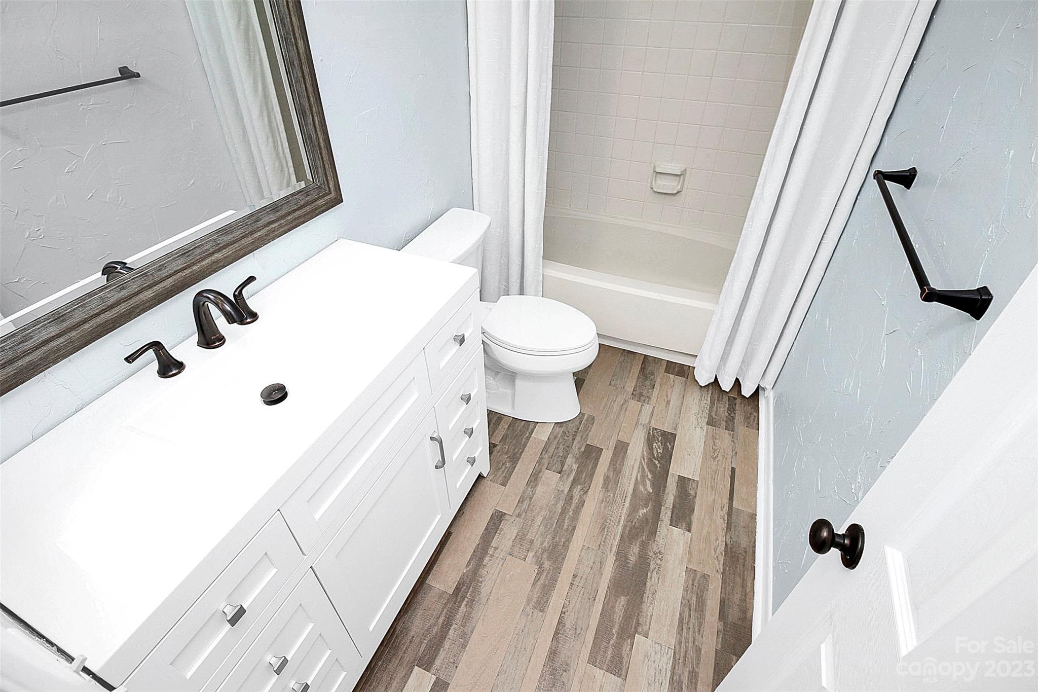 6144 Heath Ridge Court, Unit C Charlotte, NC 28210 - Photo 25 of 36 a bathroom with a sink a toilet and a bathtub