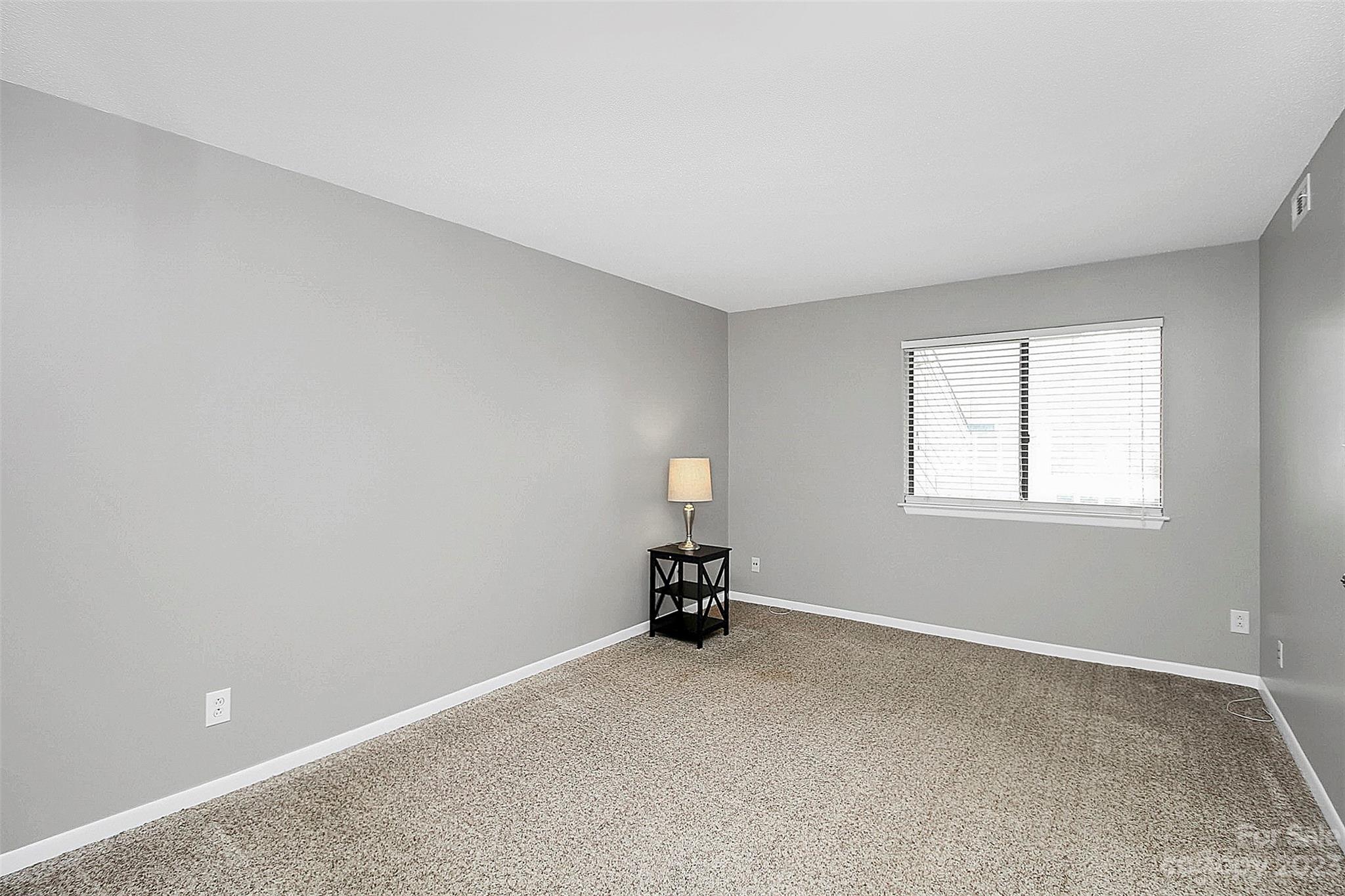 6144 Heath Ridge Court, Unit C Charlotte, NC 28210 - Photo 28 of 36 a room with a window and a lamp