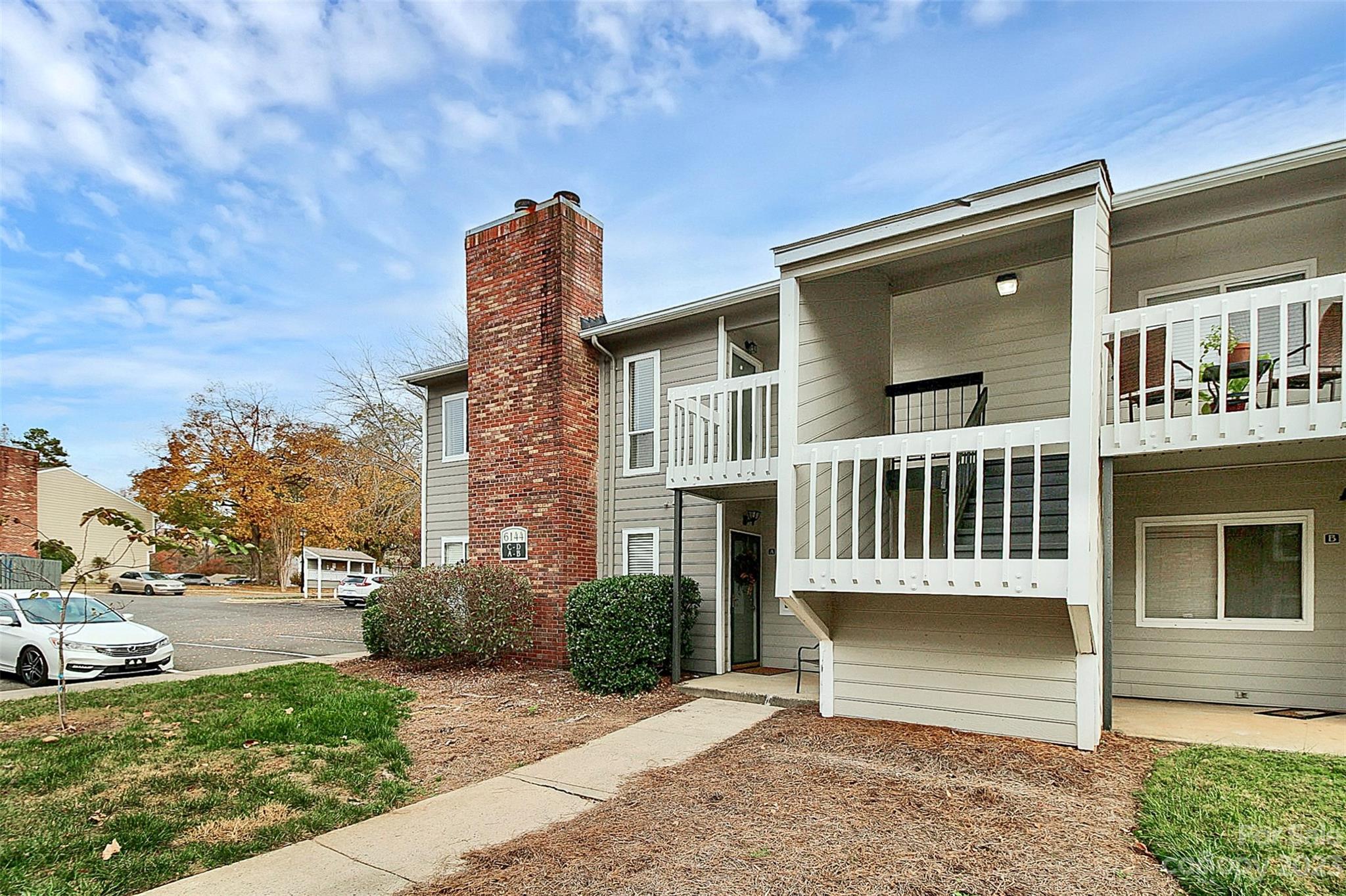 6144 Heath Ridge Court, Unit C Charlotte, NC 28210 - Photo 3 of 36 a front view of a house with a garden