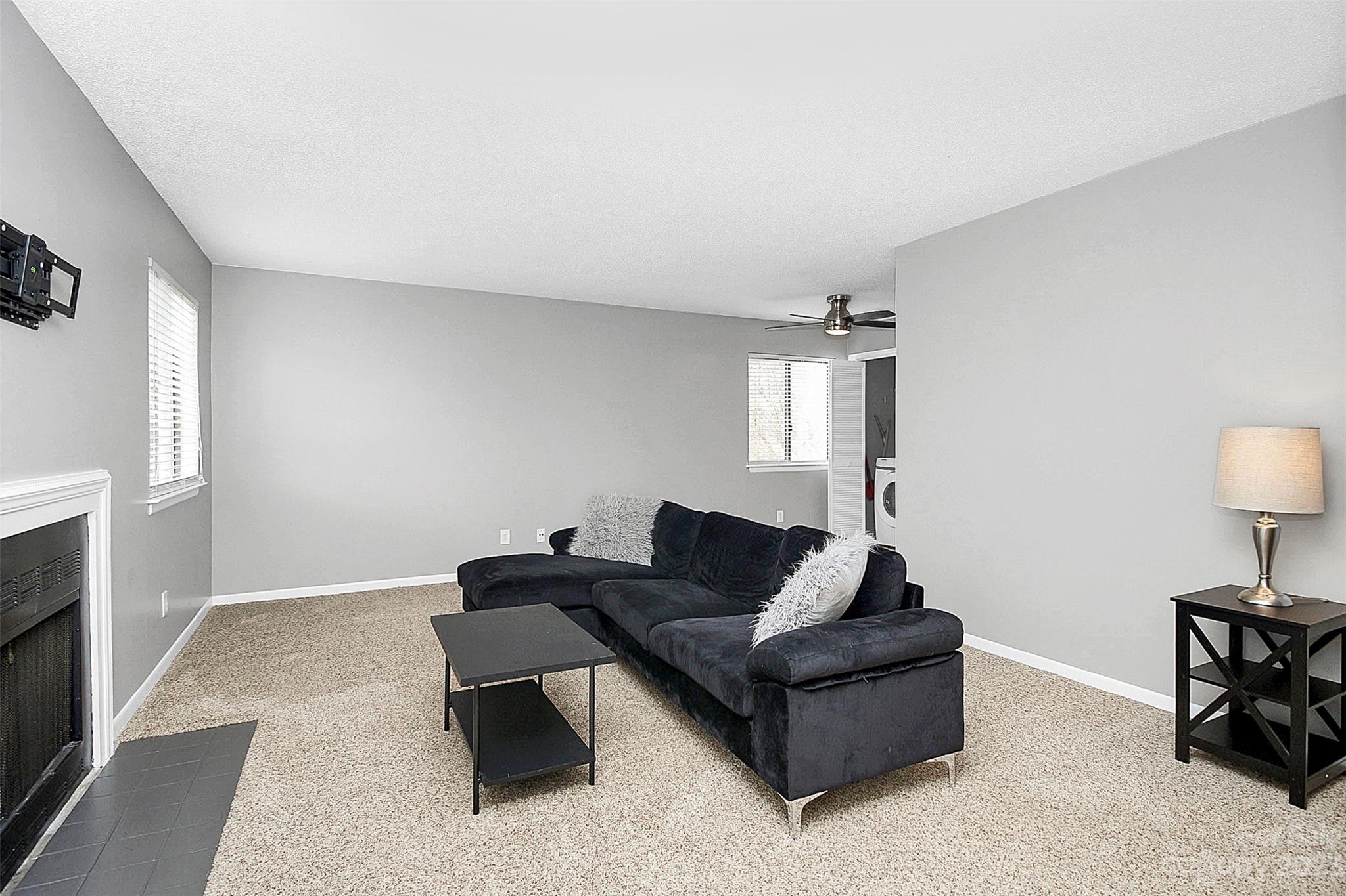 6144 Heath Ridge Court, Unit C Charlotte, NC 28210 - Photo 7 of 36 a living room with furniture and a lamp