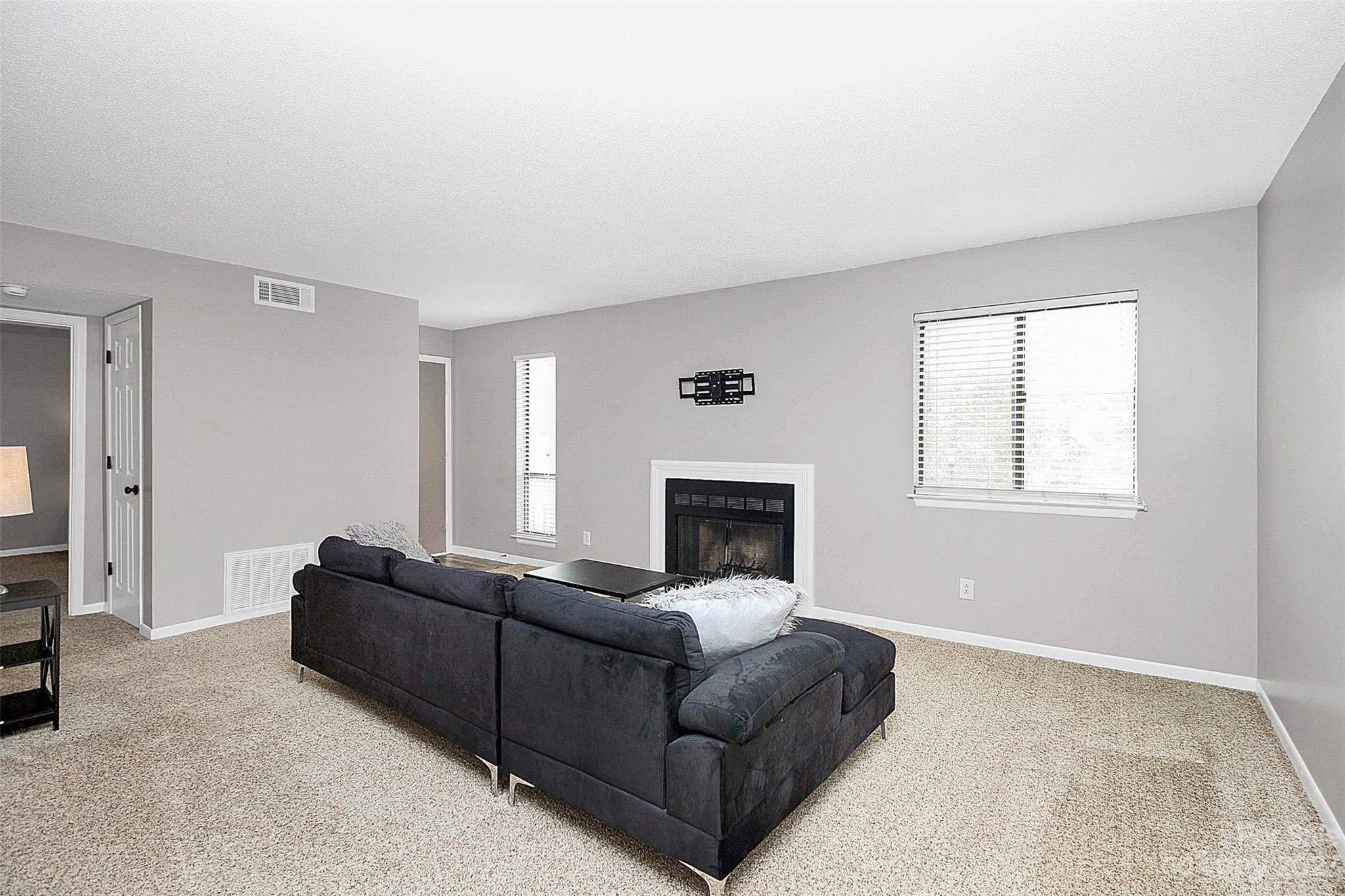 6144 Heath Ridge Court, Unit C Charlotte, NC 28210 - Photo 8 of 36 a living room with furniture and a fireplace