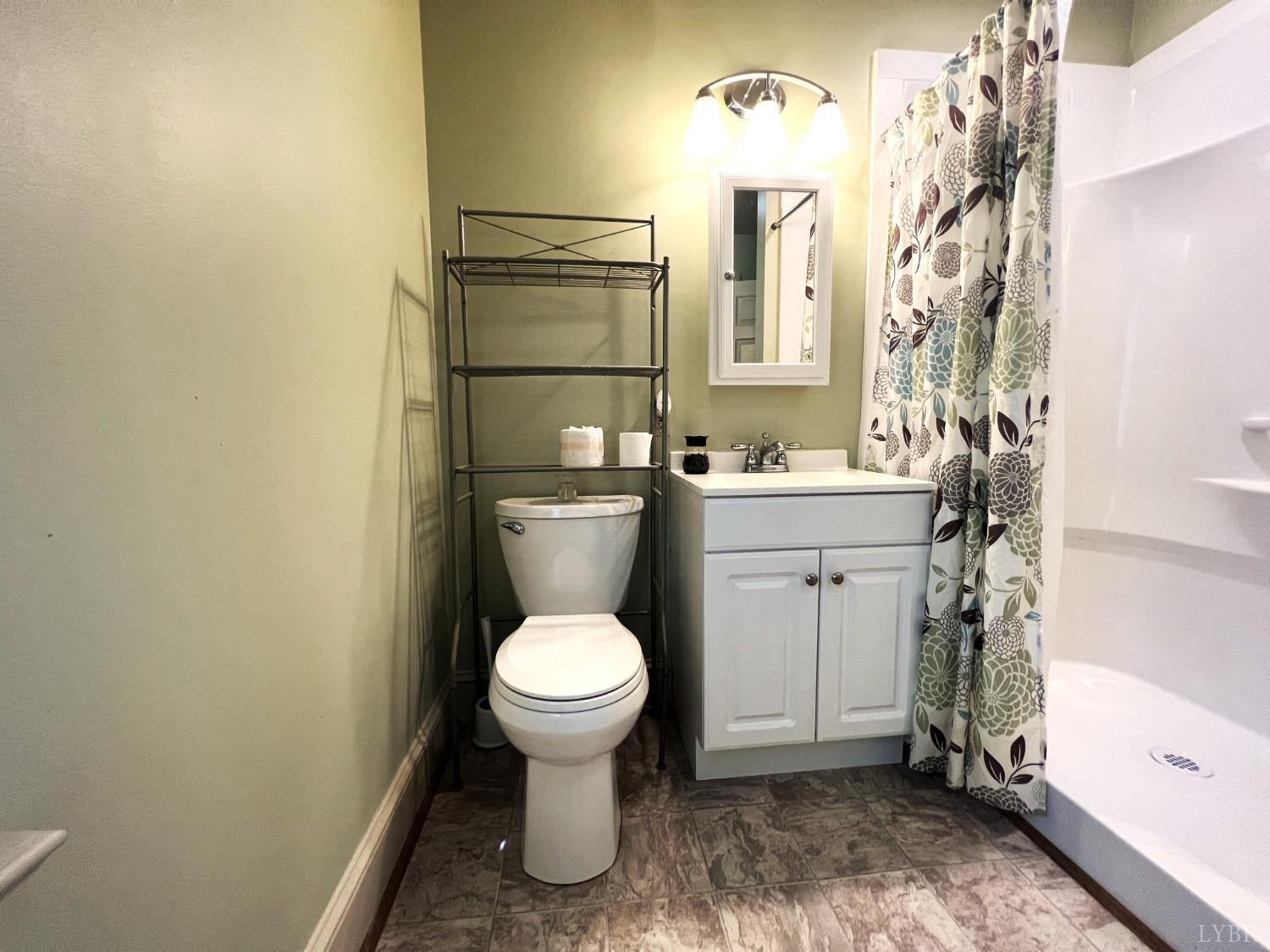 2444 Whitehead Road Keysville, VA 23947 - Photo 25 of 35 a bathroom with a sink toilet and shower