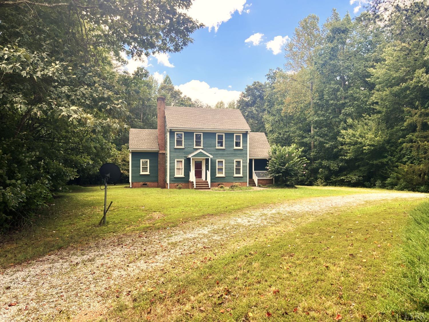 2444 Whitehead Road Keysville, VA 23947 - Photo 5 of 35 a view of house in front of a big yard with large trees