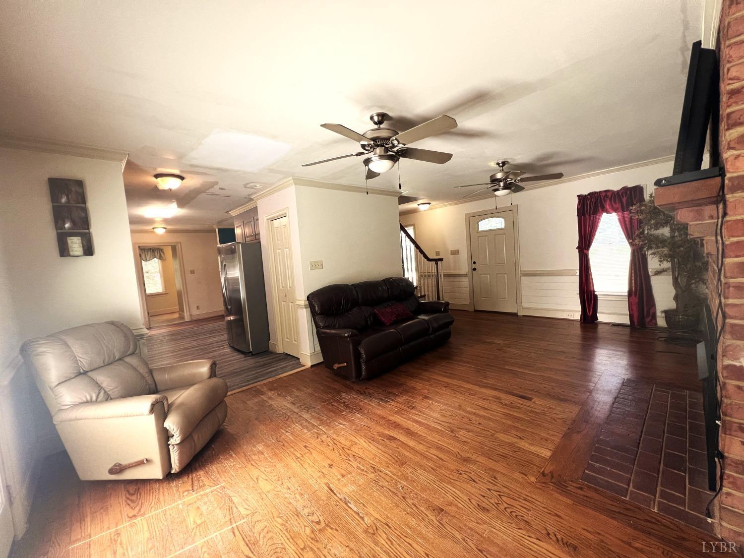 2444 Whitehead Road Keysville, VA 23947 - Photo 8 of 35 a living room with furniture and a chandelier