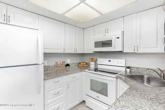 a close view of a sink a faucet and appliance in the kitchen