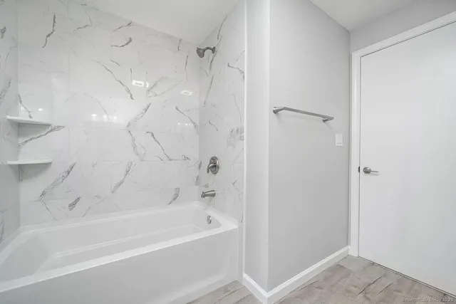 a bathroom with a bathtub and a shower